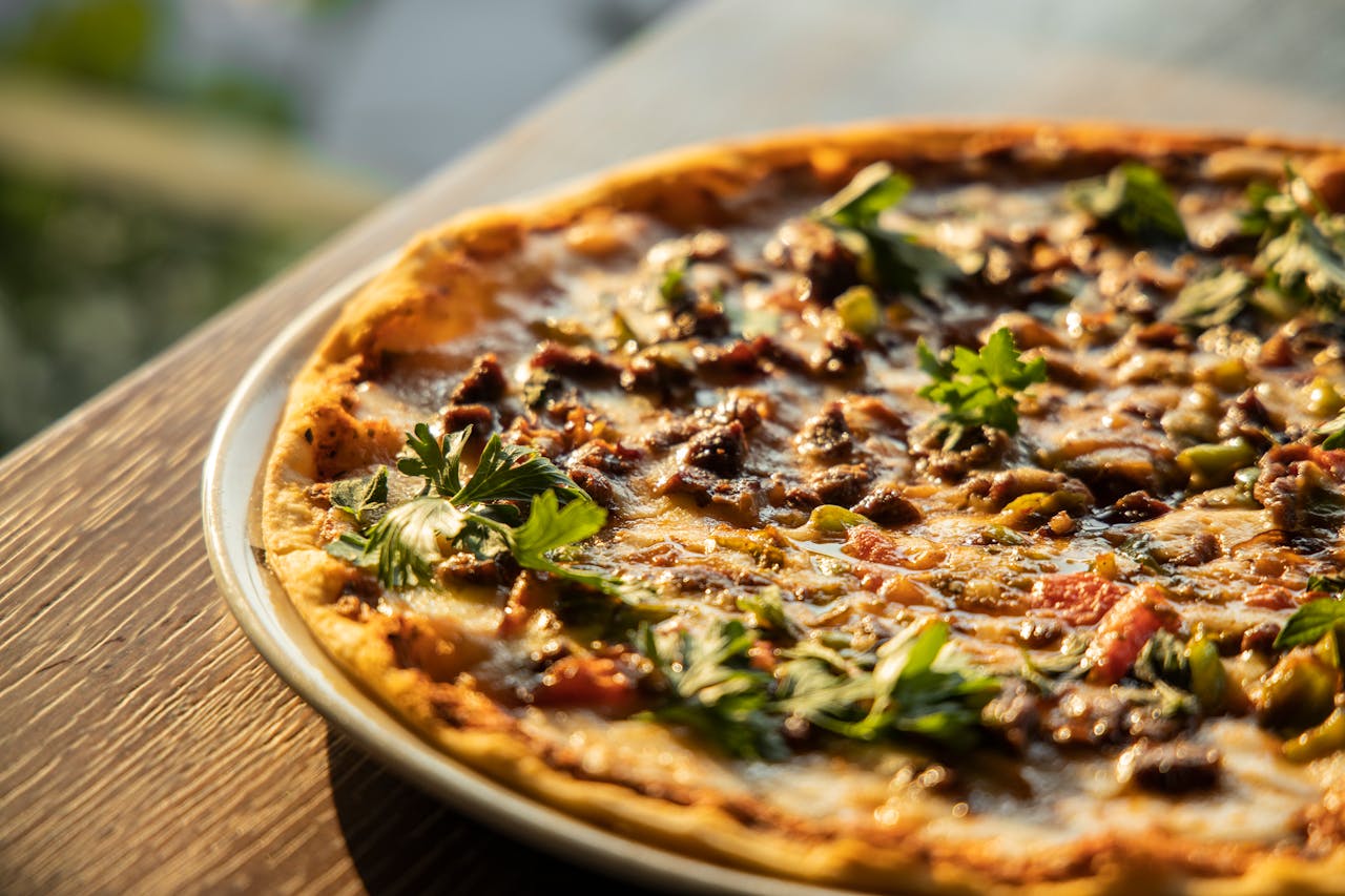 Close-up of a mouthwatering Italian-style pizza with a variety of toppings in warm lighting.